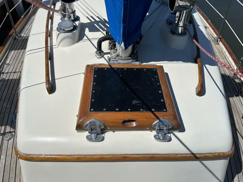 Slide: The Image of 1978 Cheoy Lee Offshore 33 sailboat deck with wooden trim and blue sail cover. - 11