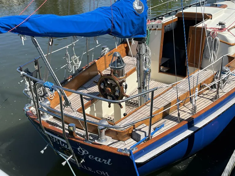 Slide: The Image of 1978 Cheoy Lee Offshore 33 sailboat with blue cover docked at marina. - 14