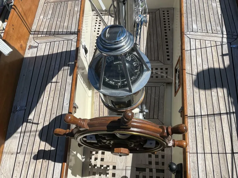 Slide: The Image of 1978 Cheoy Lee Offshore 33 sailboat helm with wooden wheel and compass. - 16