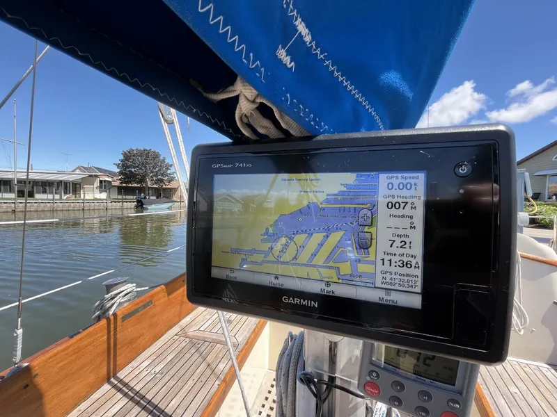Slide: The Image of Garmin GPS on 1978 Cheoy Lee Offshore 33 sailboat, docked under blue sky. - 17