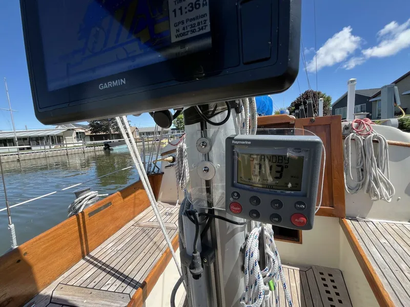 Slide: The Image of Cockpit of 1978 Cheoy Lee Offshore 33 sailboat with navigation equipment and wooden deck. - 18