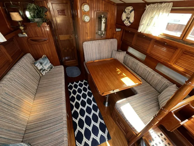 Slide: The Image of Interior of 1978 Cheoy Lee Offshore 33 sailboat with cozy seating and wooden decor. - 19