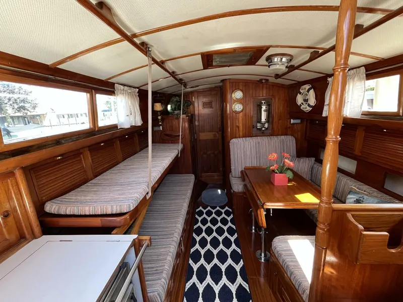 Slide: The Image of 1978 Cheoy Lee Offshore 33 yacht interior with wooden finish and cozy seating area. - 23