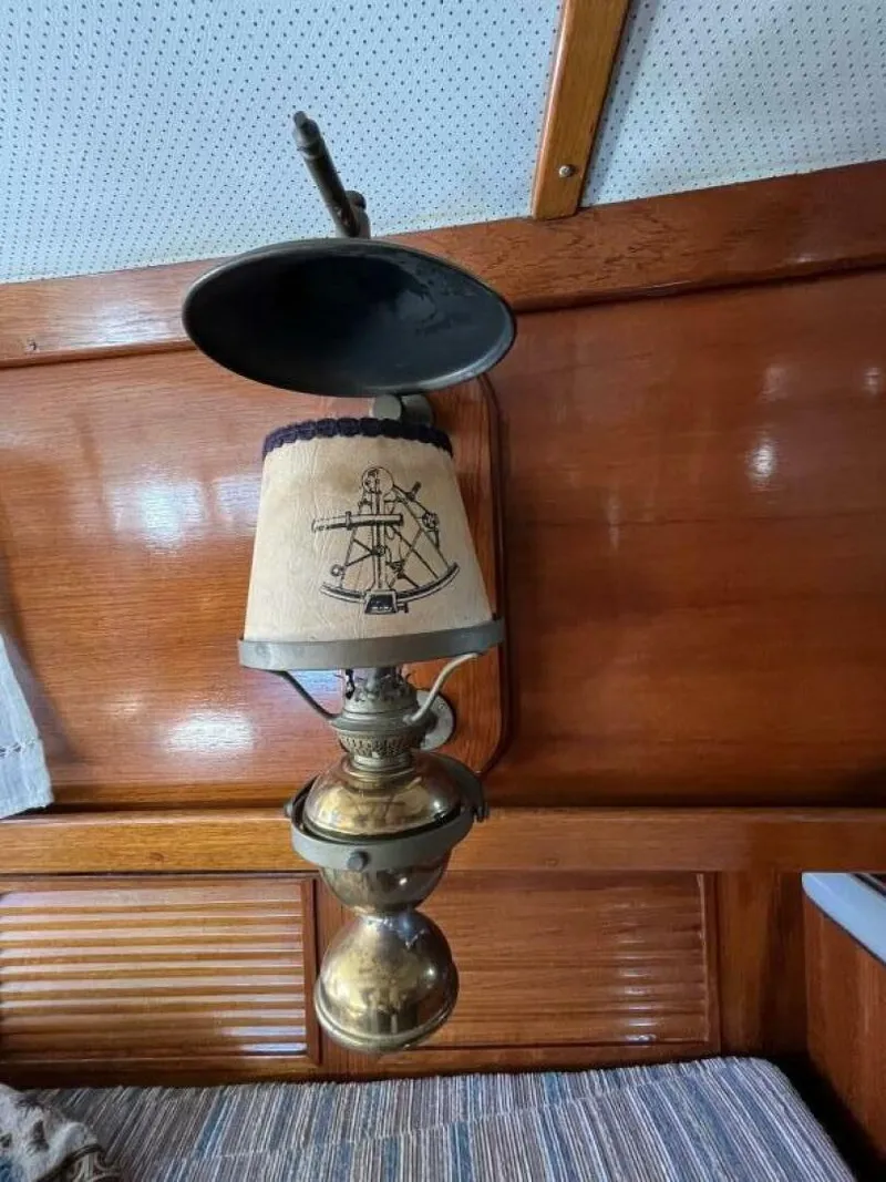 Slide: The Image of Vintage nautical lamp inside 1978 Cheoy Lee Offshore 33 yacht, featuring a maritime-themed lampshade. - 24