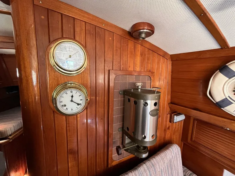 Slide: The Image of Interior of 1978 Cheoy Lee Offshore 33 with wood paneling, clock, barometer, and heater. - 25