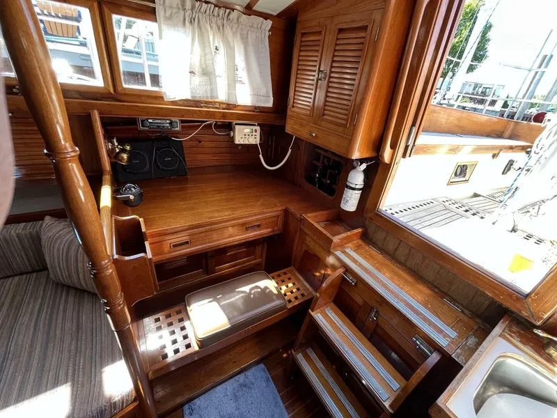 Slide: The Image of 1978 Cheoy Lee Offshore 33 interior with wooden cabinetry and navigation station. - 28