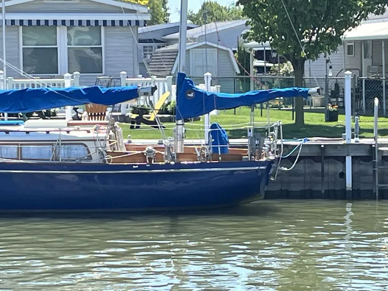 Slide: The Image of 1978 Cheoy Lee Offshore 33 sailboat docked by waterfront homes. - 3