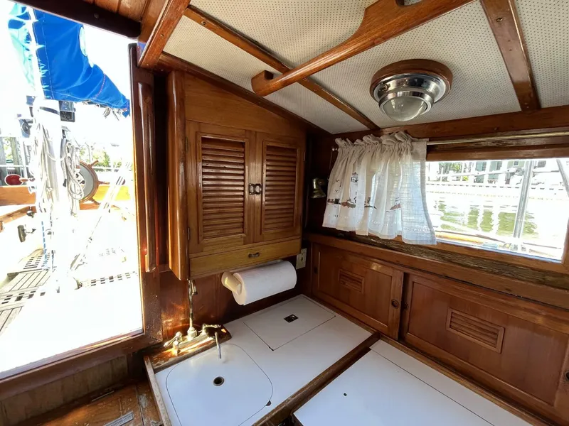 Slide: The Image of 1978 Cheoy Lee Offshore 33 yacht interior with wooden cabinetry and nautical decor. - 30