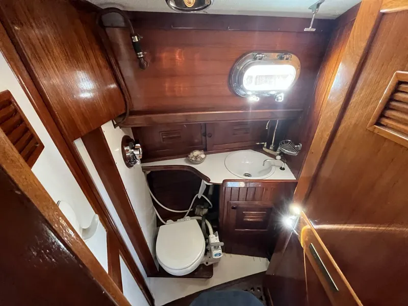 Slide: The Image of 1978 Cheoy Lee Offshore 33 yacht bathroom with wooden interior and compact amenities. - 36