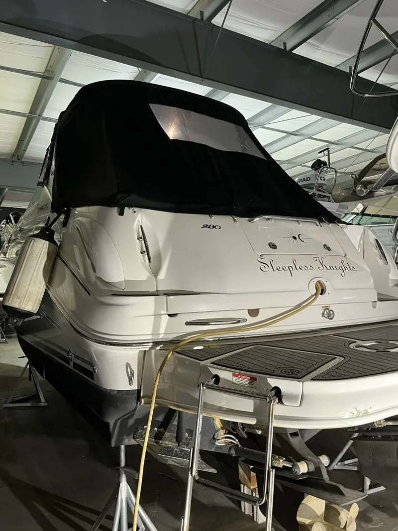 Slide: The Image of 2007 Sea Ray 280 Sundancer boat in storage, covered and elevated. - 10