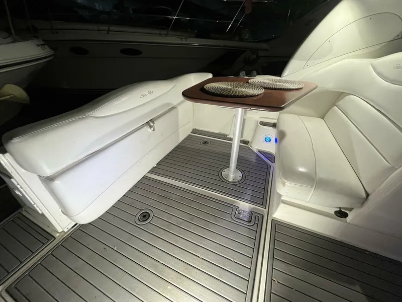 Slide: The Image of 2007 Sea Ray 280 Sundancer interior with white seating and wooden table. - 20