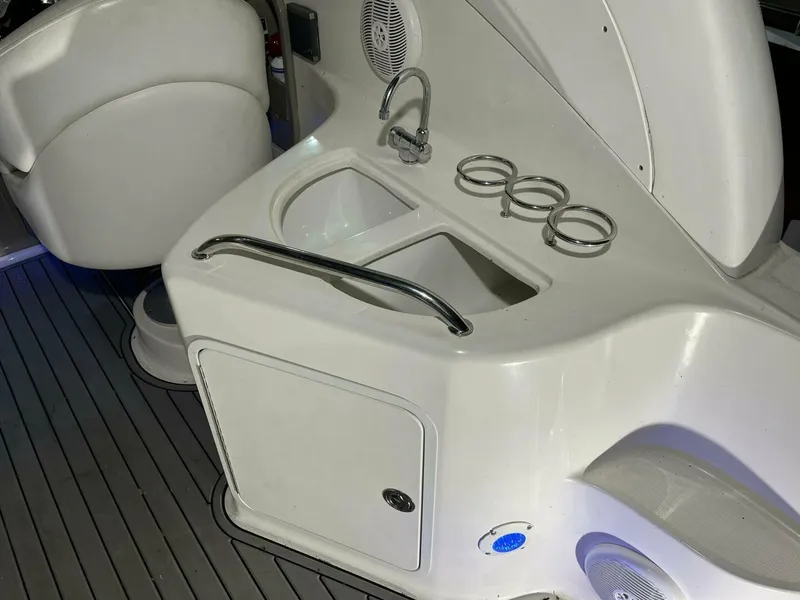 Slide: The Image of 2007 Sea Ray 280 Sundancer boat interior with sink and cup holders. - 23