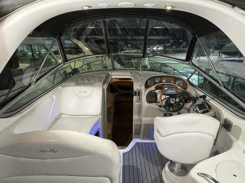 Slide: The Image of 2007 Sea Ray 280 Sundancer boat interior with helm, seating, and dashboard controls. - 26