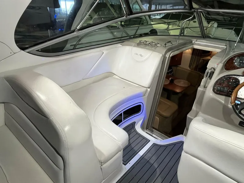 Slide: The Image of 2007 Sea Ray 280 Sundancer interior with white seating and modern dashboard. - 27