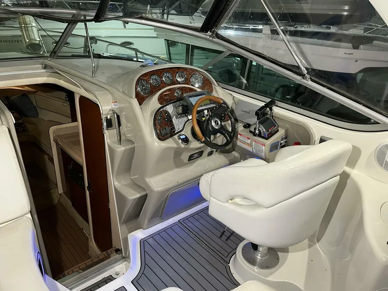 Slide: The Image of 2007 Sea Ray 280 Sundancer cockpit with steering wheel, gauges, and white captain's chair. - 28