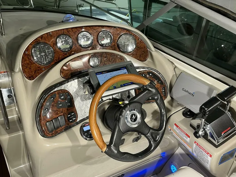 Slide: The Image of 2007 Sea Ray 280 Sundancer helm with wood accents, Garmin GPS, and modern controls. - 31
