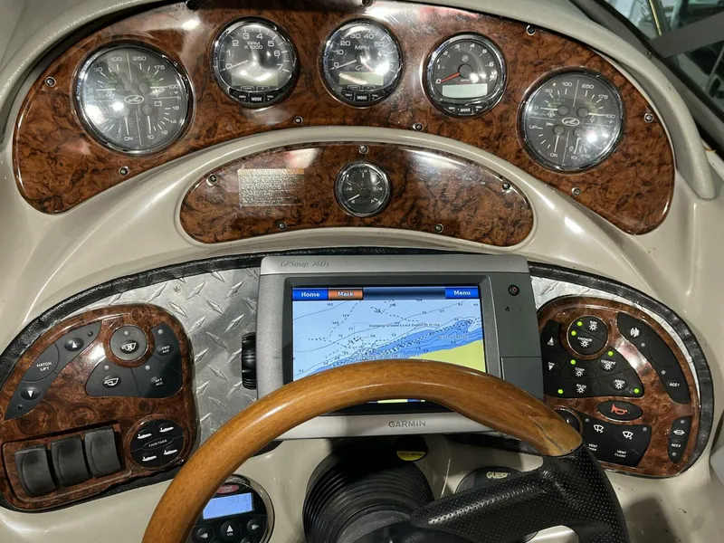 Slide: The Image of 2007 Sea Ray 280 Sundancer dashboard with GPS, gauges, and wood trim. - 32