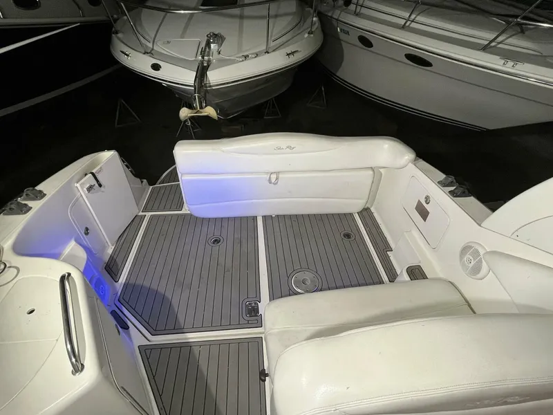 Slide: The Image of 2007 Sea Ray 280 Sundancer boat interior with white seating and gray flooring. - 34