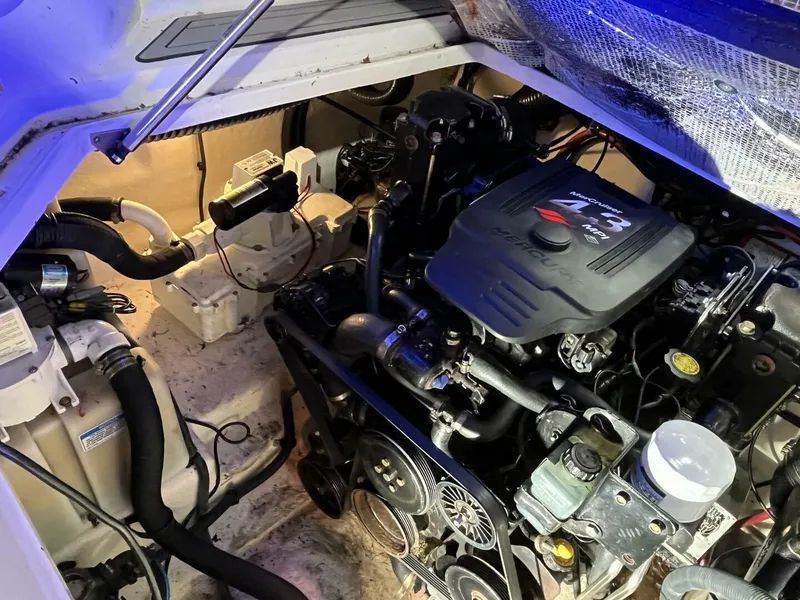 Slide: The Image of Engine compartment of a 2007 Sea Ray 280 Sundancer boat, showcasing mechanical components. - 37