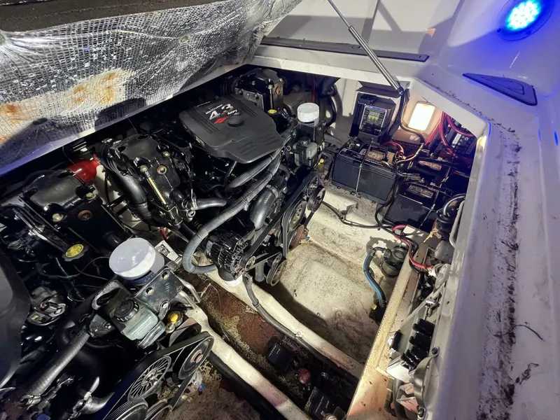 Slide: The Image of Engine compartment of a 2007 Sea Ray 280 Sundancer boat, showcasing mechanical components. - 38