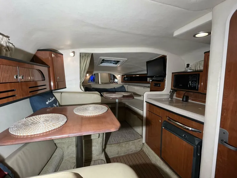 Slide: The Image of Interior of 2007 Sea Ray 280 Sundancer boat with kitchenette and seating area. - 44