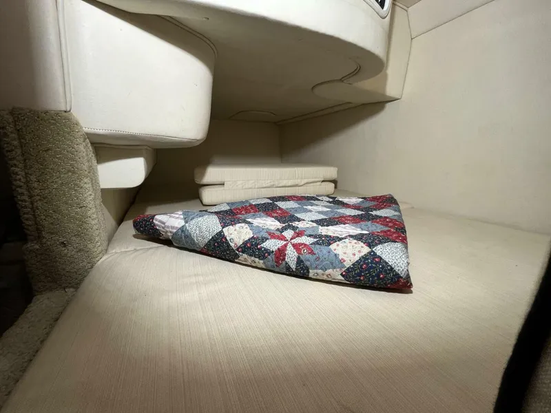 Slide: The Image of Interior cabin of 2007 Sea Ray 280 Sundancer with quilted blanket. - 49