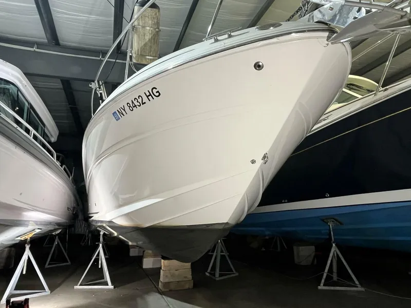 Slide: The Image of 2007 Sea Ray 280 Sundancer boat in storage, elevated on stands. - 5