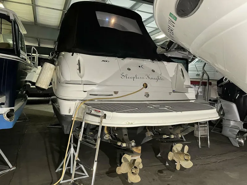 Slide: The Image of 2007 Sea Ray 280 Sundancer boat in storage, rear view with propellers visible. - 6