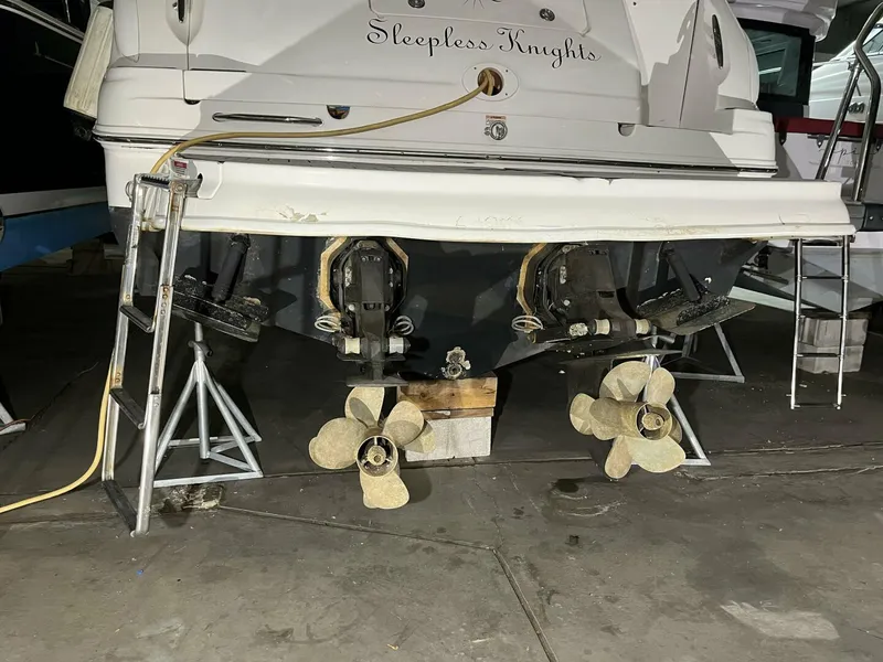 Slide: The Image of 2007 Sea Ray 280 Sundancer boat on stands, showing dual propellers and stern details. - 7