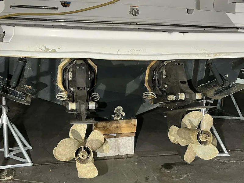 Slide: The Image of 2007 Sea Ray 280 Sundancer boat propellers and stern drive in a garage setting. - 8