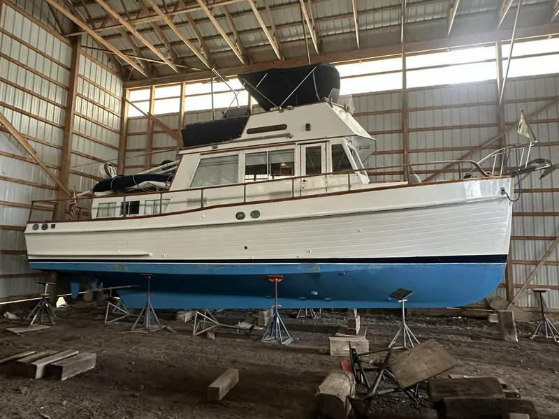 The Image of 1978 Grand Banks 36 Classic boat in storage, elevated on stands, inside a wooden structure. - 1