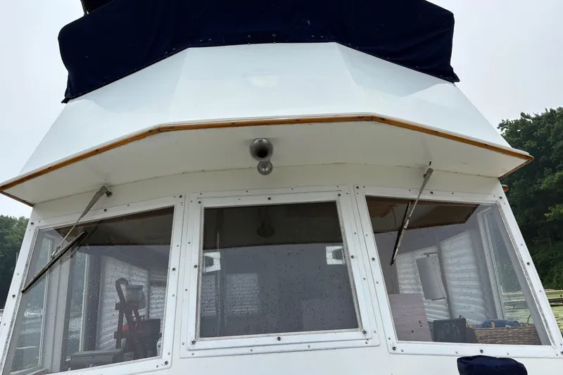 Slide: The Image of 1978 Grand Banks 36 Classic boat, front view with windows and canopy. - 13