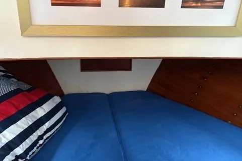 Slide: The Image of Cozy cabin interior of 1978 Grand Banks 36 Classic with blue bedding and striped pillow. - 16