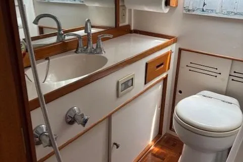 Slide: The Image of 1978 Grand Banks 36 Classic yacht bathroom with sink, faucet, and toilet. - 17