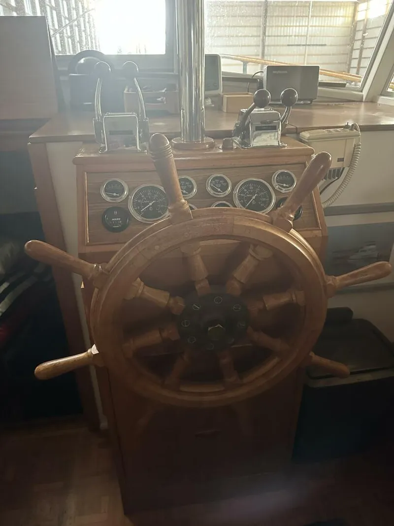 Slide: The Image of 1978 Grand Banks 36 Classic helm with wooden steering wheel and instrument panel. - 2