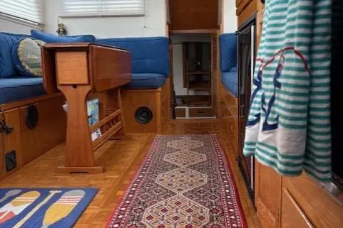 Slide: The Image of Interior of a 1978 Grand Banks 36 Classic yacht with wooden furnishings and blue seating. - 20