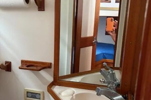 Slide: The Image of 1978 Grand Banks 36 Classic yacht bathroom with wooden accents and mirror reflection. - 21