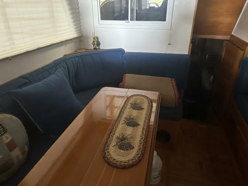 Slide: The Image of Interior of 1978 Grand Banks 36 Classic with blue seating and wooden table. - 4
