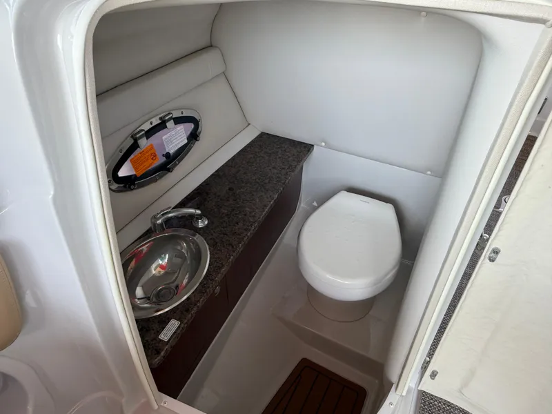Slide: The Image of 2019 Crownline Eclipse E255 XS boat interior bathroom with sink and toilet. - 13