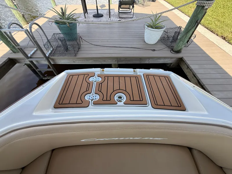 Slide: The Image of 2019 Crownline Eclipse E255 XS boat with teak deck, docked by a wooden pier. - 14