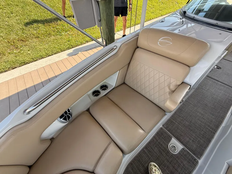 Slide: The Image of 2019 Crownline Eclipse E255 XS boat interior with tan leather seating and cup holders. - 9
