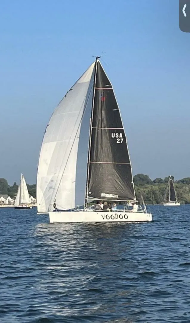 The Image of Sailboat Farr 30, 1996 model, sailing on a calm lake with other boats in the background. - 1