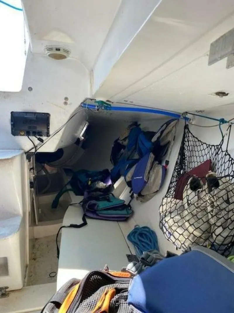 Slide: The Image of Interior of a 1996 Farr 30 sailboat with gear and storage nets. - 12