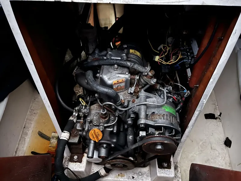 Slide: The Image of Engine of a 1996 Farr 30 sailboat, showcasing mechanical components and wiring. - 14