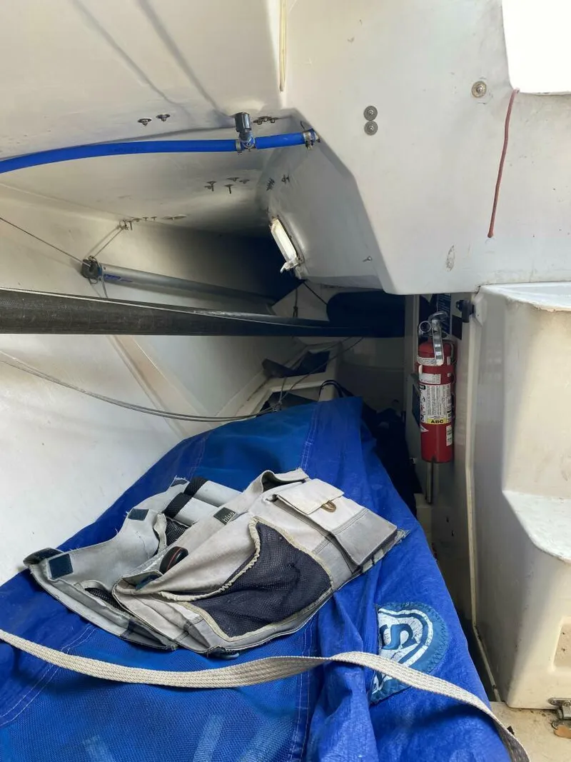 Slide: The Image of Interior of a 1996 Farr 30 sailboat, featuring storage and safety equipment. - 15