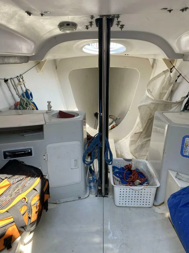 Slide: The Image of Interior of a 1996 Farr 30 sailboat, featuring storage and nautical equipment. - 16