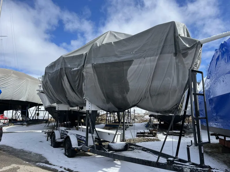 Slide: The Image of Covered 1996 Farr 30 sailboat on trailer in snowy boatyard. - 17
