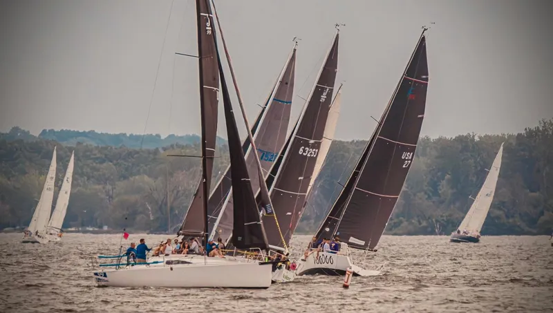 Slide: The Image of Sailboats racing on a lake, featuring a 1996 Farr 30 model. - 18