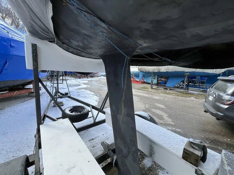 Slide: The Image of 1996 Farr 30 sailboat keel on trailer in a snowy boatyard. - 3
