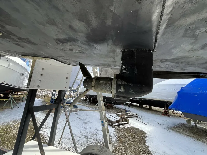Slide: The Image of Underside view of a 1996 Farr 30 sailboat with visible propeller and support stands. - 5